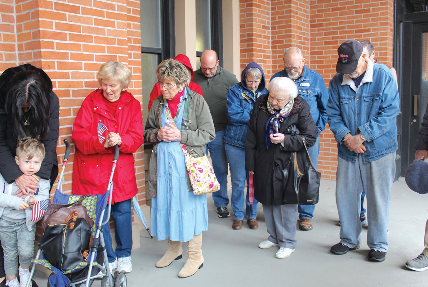 A group of devoted Christians bow their heads during one of the many prayers spoken aloud Thursday on the courthouse patio.